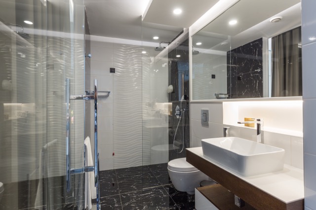 Interior of a luxury hotel bathroom with glass shower cabin